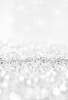 black and white photograph of sparkling lights on a silver glittered surface with sparkles in the background