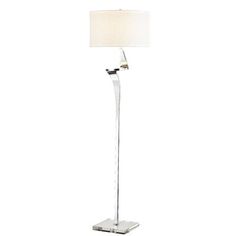 a floor lamp with a white shade on it