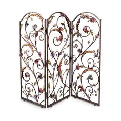 an ornate iron screen with flowers and leaves on the sides, set against a white background