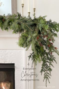 a fireplace with candles and greenery hanging from the mantle