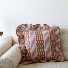 a white couch with a pillow on top of it