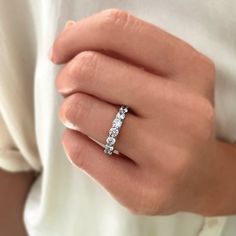 a woman's hand with a diamond ring on it