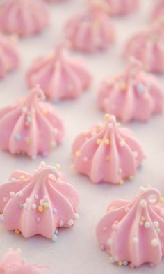 pink frosted cookies with sprinkles on them