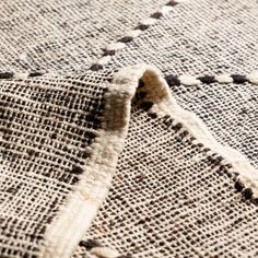 a close up view of the fabric on a rug with holes in it that are missing