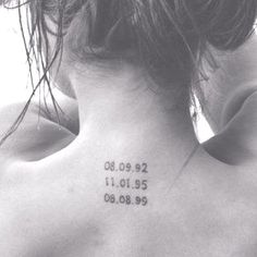 the back of a woman's neck with numbers on it