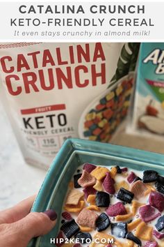 a person holding a bowl of cereal in front of a carton of catalina crunch