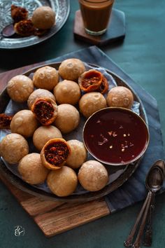 some food is sitting on a plate with dipping sauce