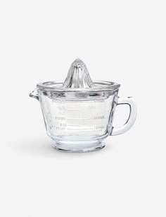 a glass measuring cup with a lid