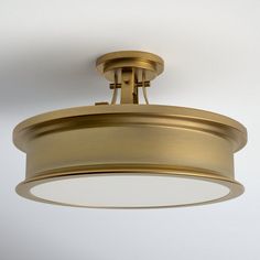 an overhead light fixture on a white wall