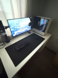 two computer monitors sitting on top of a white desk