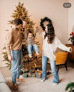 a family standing in front of a christmas tree