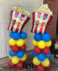 two balloons are stacked on top of each other in front of a garage door, with the words welcome to pahrina written on them