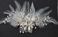 a bridal hair comb with flowers and feathers