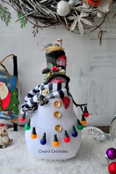 a snowman made out of buttons and other decorations