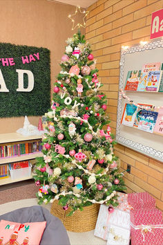 a decorated christmas tree with pink and white ornaments in a library area next to bookshelves