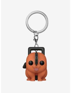 a keychain shaped like an orange dog with a black nose and head on it