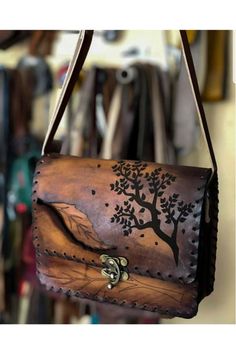 a brown leather purse hanging from a hook