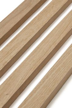 four pieces of wood are shown in this close up shot, including the slats