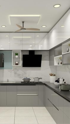 a modern kitchen with marble counter tops and stainless steel appliances, along with ceiling fans