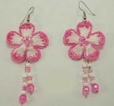 pink and white crocheted flower earrings with dangling bead hooks, on a white background