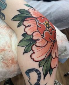 a woman's arm with flowers on it and a snake in the middle of her arm