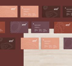 several business cards are arranged on top of each other, with different colors and shapes