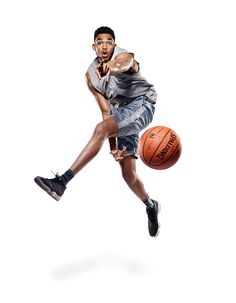 a man is jumping in the air with a basketball on his feet and one leg up