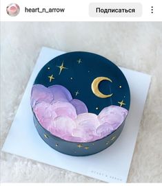 there is a cake decorated with the moon and clouds