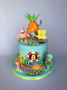 a birthday cake with spongebob and friends on it's bottom tiers