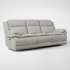 the reclining sofa is made from fabric and has two pillows on each arm, which are