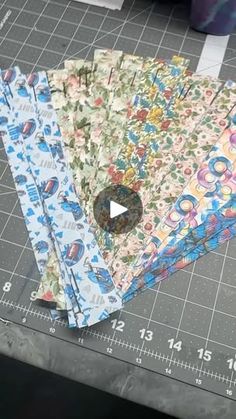 four pieces of fabric laid out on top of a cutting board next to a ruler