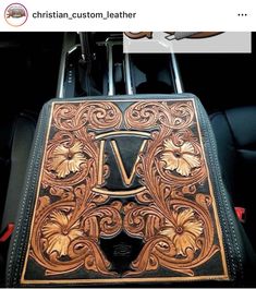 the inside of a car with an intricate leather seat cover and floral design on it