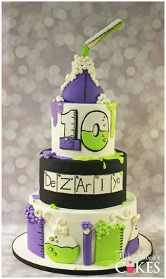 a three tiered cake decorated in purple and green