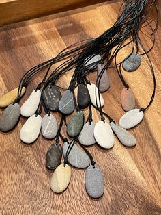 a bunch of stones sitting on top of a wooden floor next to a string of lights