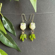 These bright green owls in their bed of green leaves will be a fun addition for any outfit. Playful Green Earrings For Summer, Playful Green Summer Jewelry, Summer Green Playful Jewelry, Green Handmade Fun Earrings, Cute Adjustable Green Earrings, Spring Green Dangle Earrings, Green Dangle Earrings For Spring, Green Dangle Earrings With Fun Style, Trendy Green Earrings For Spring