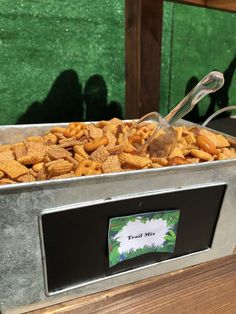 a metal container filled with cheetos sitting on top of a wooden table