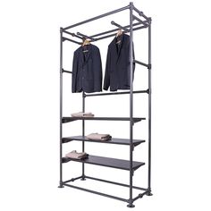 an iron clothing rack with two suits on it