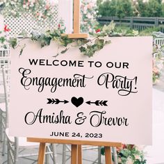 a welcome sign for an engagement party with greenery on it and the words'welcome to our engagement party, amisha & trever '