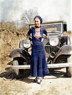 a woman standing next to an old car