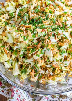 a large glass bowl filled with coleslaw and carrots