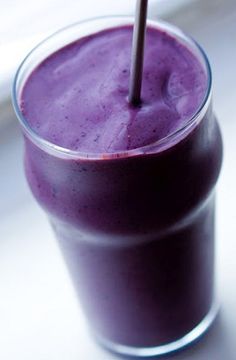 a purple smoothie in a glass with a straw sticking out of it's top