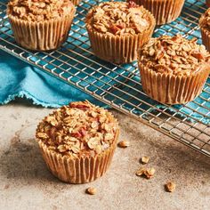 several muffins on a cooling rack with blue cloth