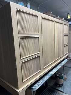 a large wooden cabinet sitting on top of a metal shelf