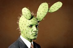 a man in a suit and tie with cactus like hair on his head that says dudes be like yo no como frioles