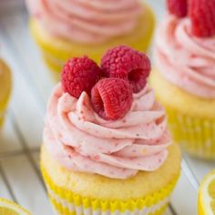 several cupcakes with raspberries and lemon slices