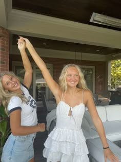 two beautiful young women standing next to each other