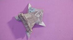 an origami star on a purple background