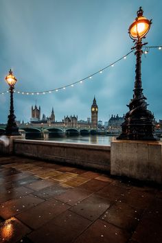 the big ben clock tower towering over the city of london at night with lights on