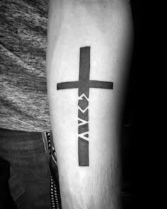 a black and white photo of a cross tattoo