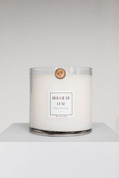 a white candle sitting on top of a table